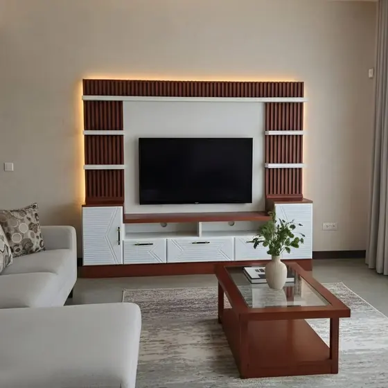Red and white marble TV unit with warm living room styling, completed by Lucky Enterprises